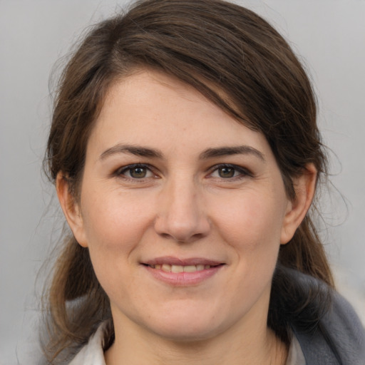 Joyful white young-adult female with medium  brown hair and brown eyes