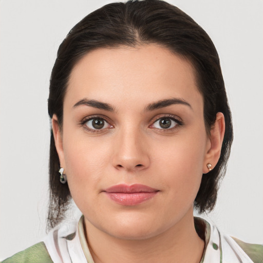 Joyful white young-adult female with medium  brown hair and brown eyes