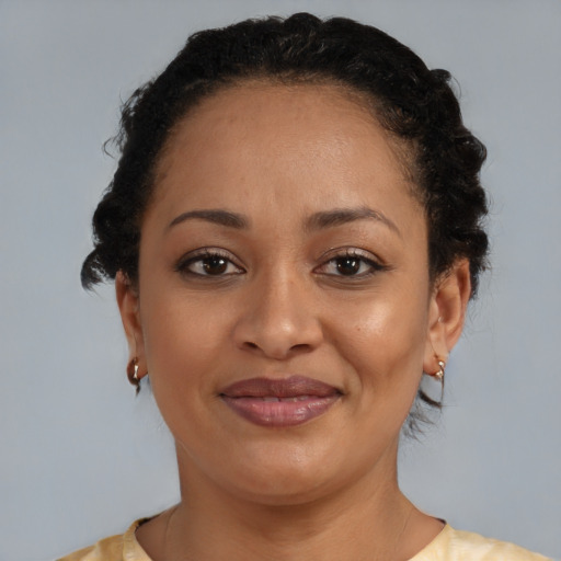 Joyful black young-adult female with medium  brown hair and brown eyes