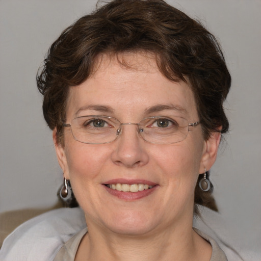 Joyful white adult female with medium  brown hair and blue eyes