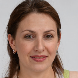 Joyful white adult female with medium  brown hair and grey eyes