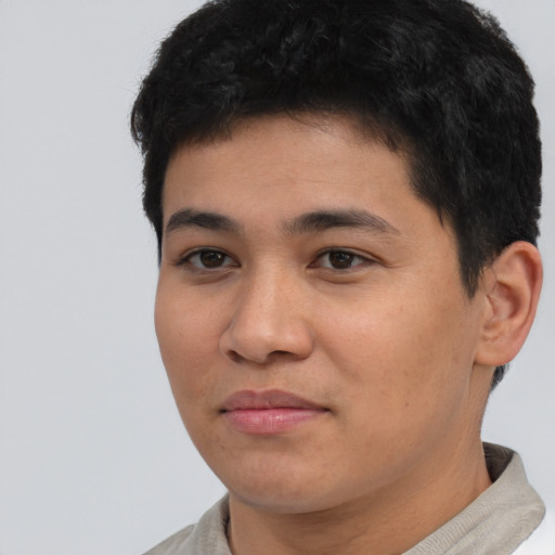 Joyful asian young-adult male with short  black hair and brown eyes