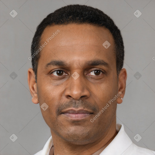 Neutral latino adult male with short  black hair and brown eyes