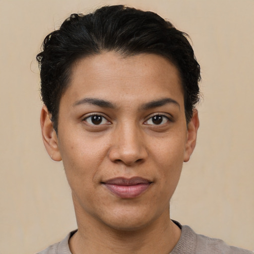 Joyful latino young-adult female with short  black hair and brown eyes