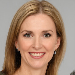 Joyful white young-adult female with medium  brown hair and green eyes