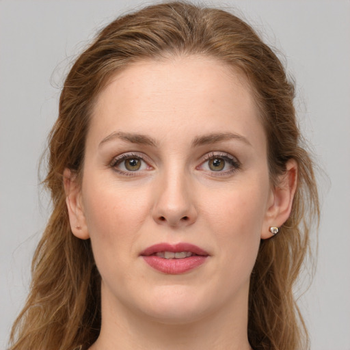 Joyful white young-adult female with long  brown hair and green eyes