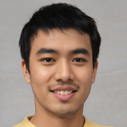 Joyful asian young-adult male with short  black hair and brown eyes