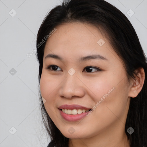 Joyful asian young-adult female with long  brown hair and brown eyes