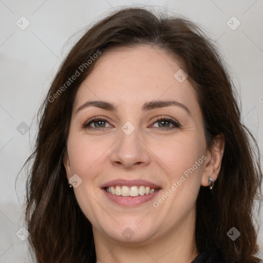 Joyful white adult female with long  brown hair and brown eyes