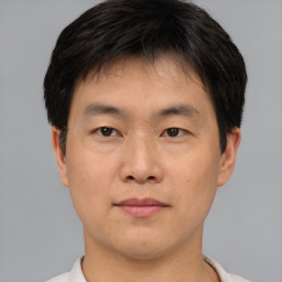 Neutral asian young-adult male with short  brown hair and brown eyes