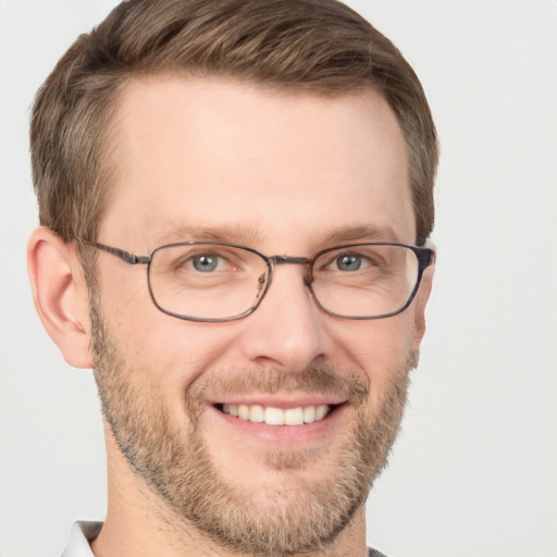 Joyful white adult male with short  brown hair and grey eyes