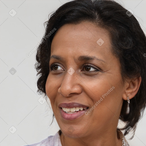 Joyful black adult female with medium  brown hair and brown eyes