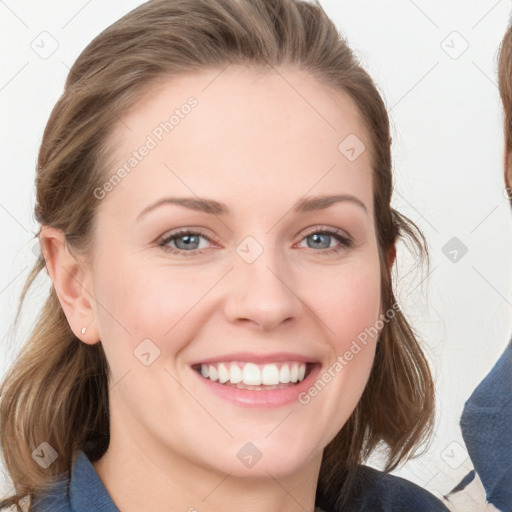 Joyful white young-adult female with medium  brown hair and blue eyes