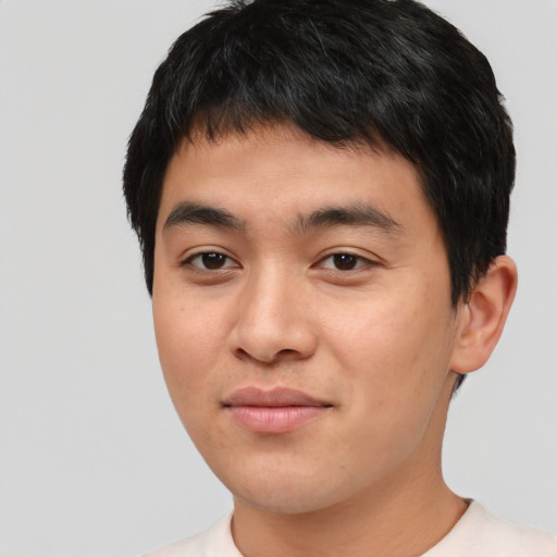 Joyful asian young-adult male with short  black hair and brown eyes