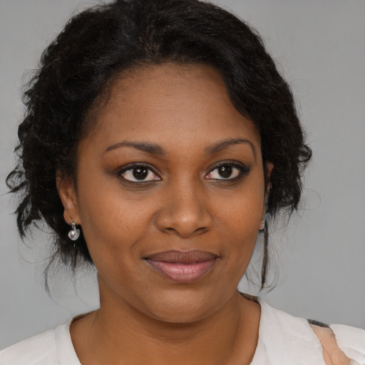 Joyful black young-adult female with medium  brown hair and brown eyes
