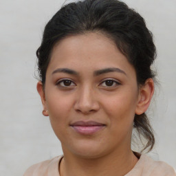 Joyful latino young-adult female with short  brown hair and brown eyes