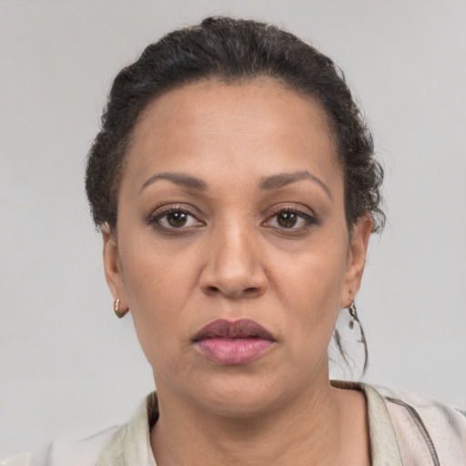 Joyful latino adult female with short  brown hair and brown eyes