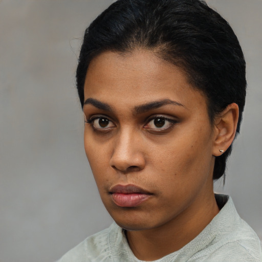 Neutral latino young-adult female with short  black hair and brown eyes