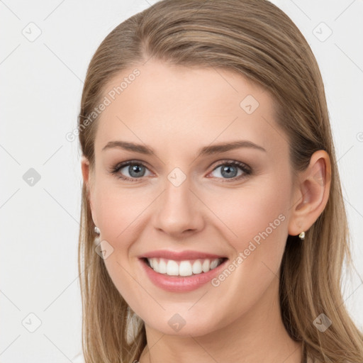 Joyful white young-adult female with long  brown hair and blue eyes