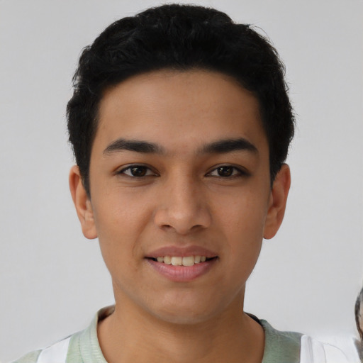 Joyful latino young-adult male with short  black hair and brown eyes