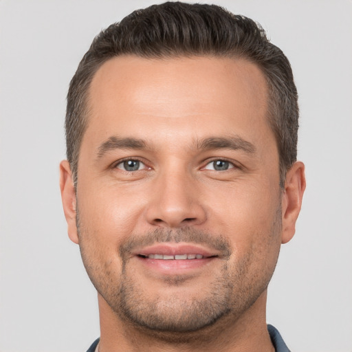 Joyful white young-adult male with short  brown hair and brown eyes