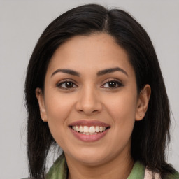 Joyful latino young-adult female with long  brown hair and brown eyes