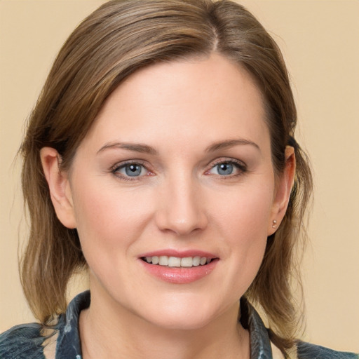 Joyful white young-adult female with medium  brown hair and blue eyes