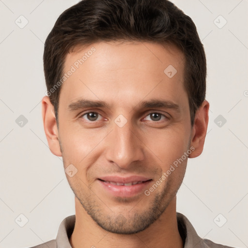 Joyful white young-adult male with short  brown hair and brown eyes