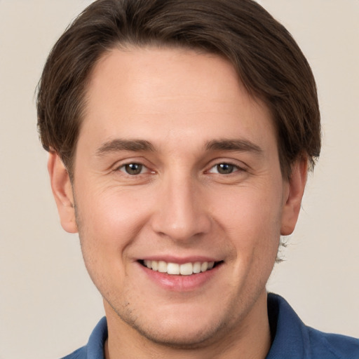 Joyful white young-adult male with short  brown hair and brown eyes