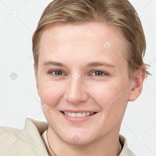 Joyful white young-adult female with short  brown hair and blue eyes