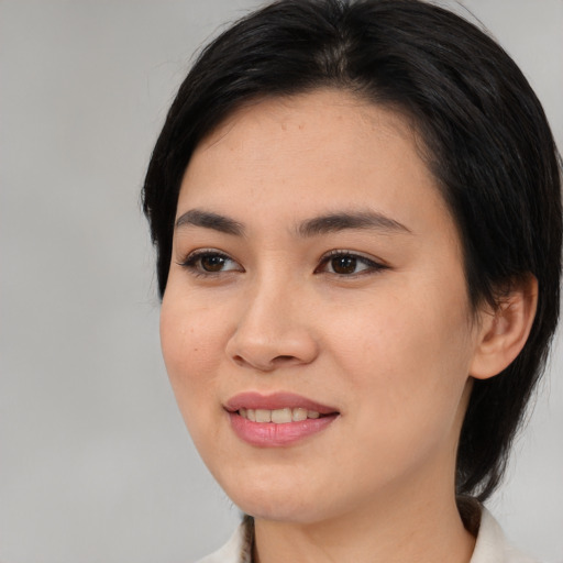 Joyful asian young-adult female with medium  black hair and brown eyes