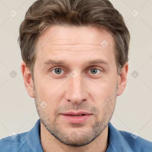 Joyful white adult male with short  brown hair and grey eyes