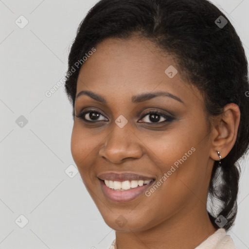 Joyful black young-adult female with short  brown hair and brown eyes