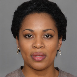 Joyful black young-adult female with short  brown hair and brown eyes