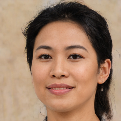 Joyful asian young-adult female with medium  brown hair and brown eyes