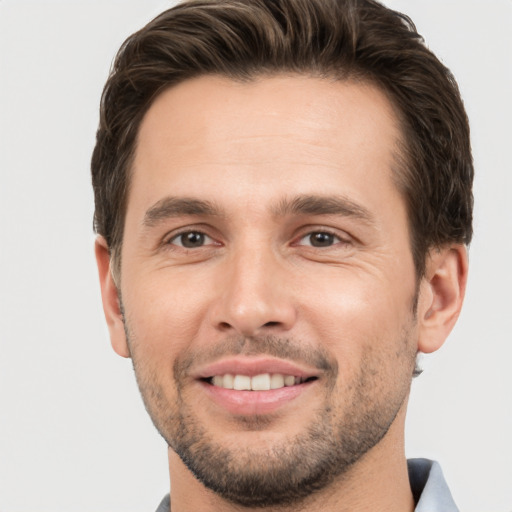 Joyful white young-adult male with short  brown hair and brown eyes