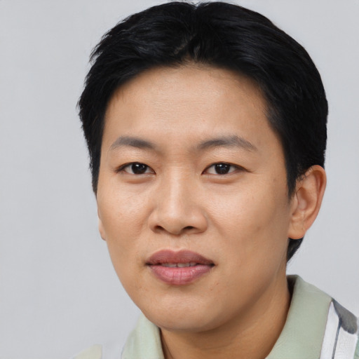 Joyful asian young-adult female with short  black hair and brown eyes