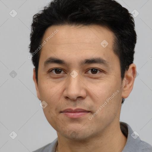 Joyful asian young-adult male with short  black hair and brown eyes