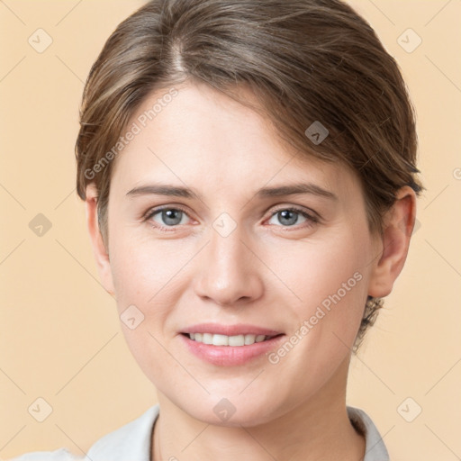 Joyful white young-adult female with short  brown hair and grey eyes