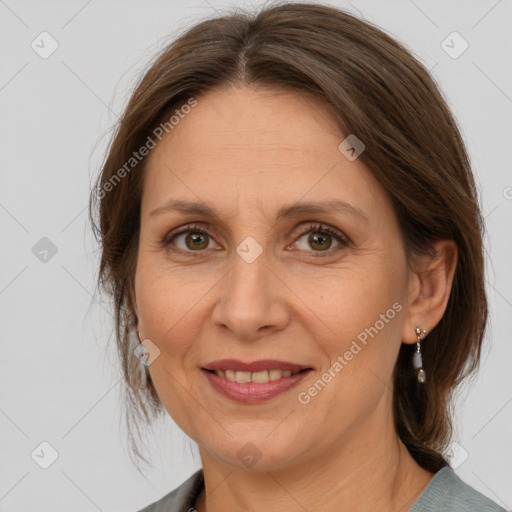 Joyful white adult female with medium  brown hair and grey eyes