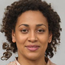 Joyful black adult female with medium  brown hair and brown eyes