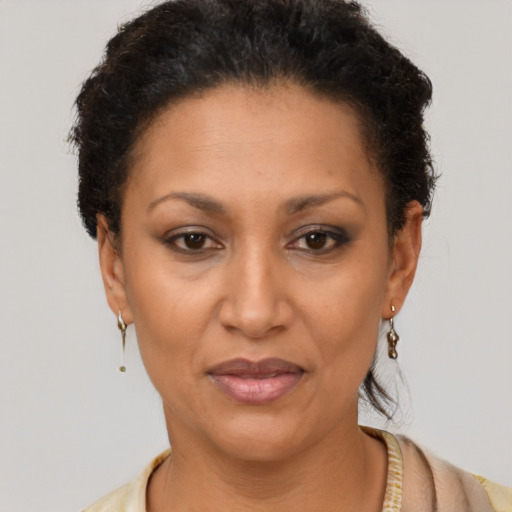 Joyful latino adult female with short  brown hair and brown eyes
