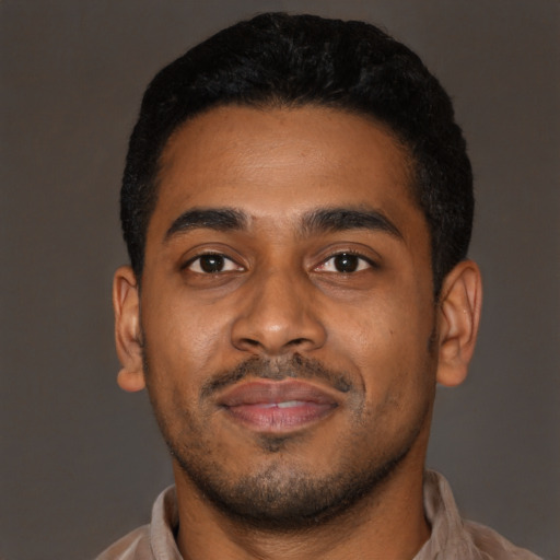 Joyful latino young-adult male with short  black hair and brown eyes