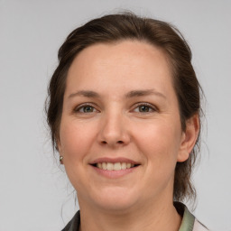 Joyful white adult female with medium  brown hair and grey eyes