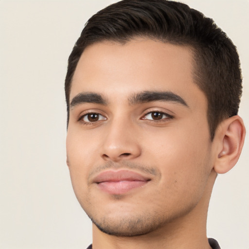 Joyful white young-adult male with short  black hair and brown eyes