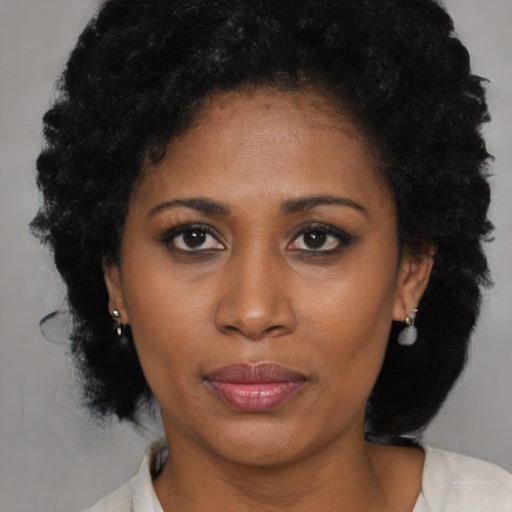 Joyful black young-adult female with medium  black hair and brown eyes