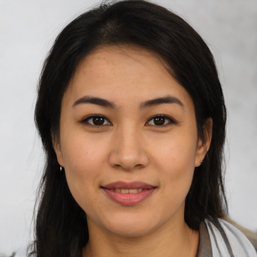 Joyful latino young-adult female with medium  brown hair and brown eyes