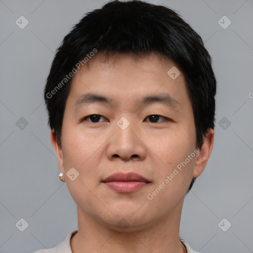 Joyful asian young-adult male with short  black hair and brown eyes