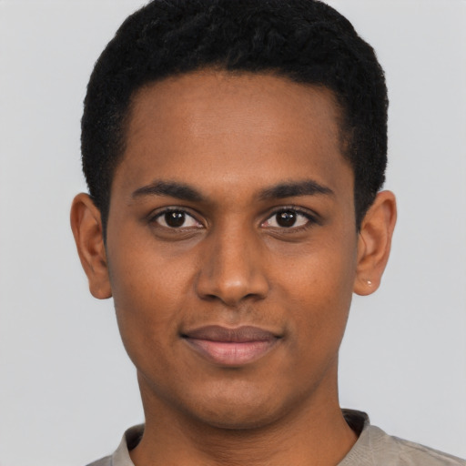 Joyful black young-adult male with short  black hair and brown eyes