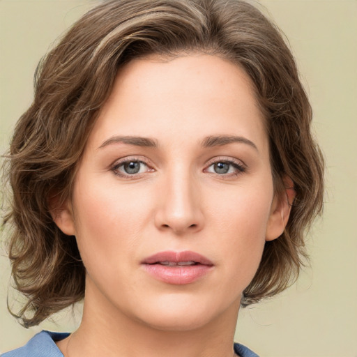 Joyful white young-adult female with medium  brown hair and green eyes